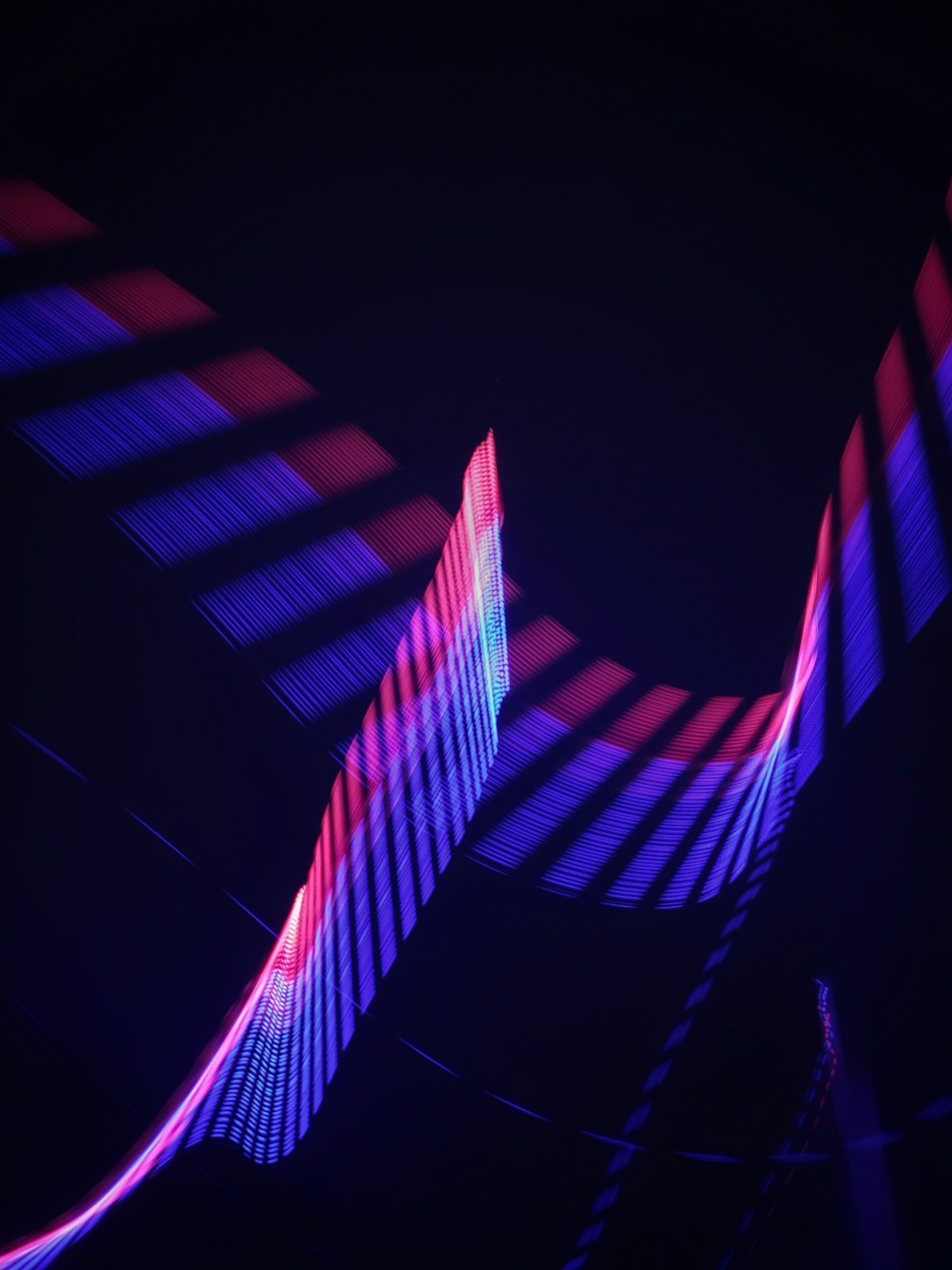 Blue and fuchsia light movement on a dark background